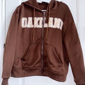 woman’s brown Oakland jacket